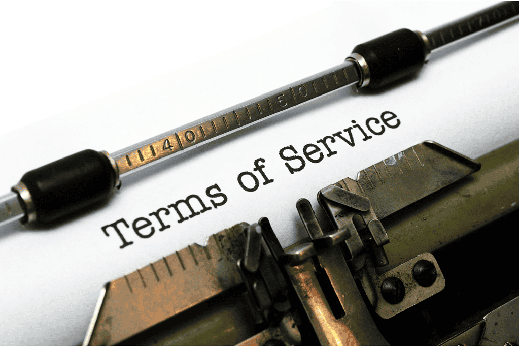 Typewriter typing 'Terms of Service' on paper for legal document.